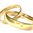 Two gold rings - reflected candles